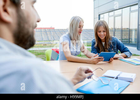 Businesswomen using digital tablet in workshop Stock Photo