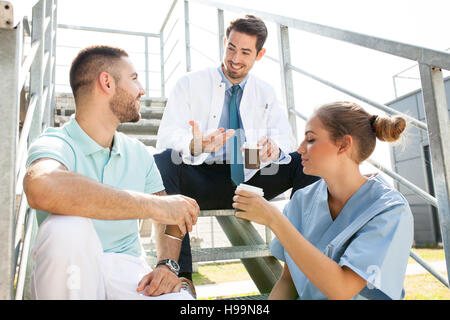 Healthcare workers taking a coffee break outdoors Stock Photo