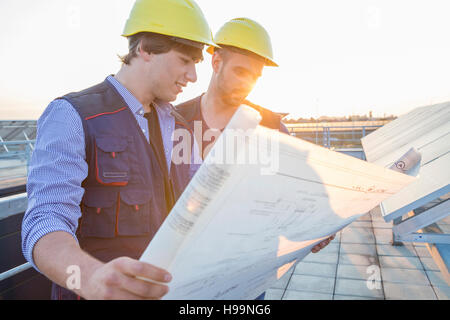 Architect and engineer inspecting solar power station Stock Photo