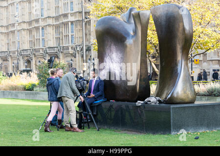 Sky News' political editor Faisal Islam filing a report outside the Houses of Parliament in London, UK Stock Photo
