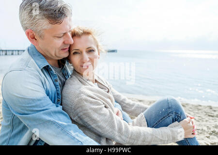 Portrait of couple in love relaxing on beach Stock Photo