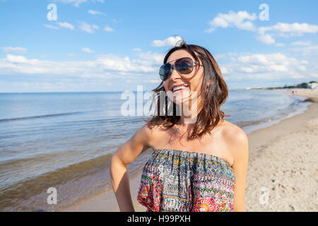 Portrait of woman with sunglasses on beach Stock Photo