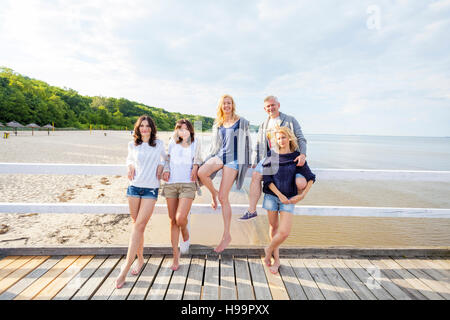 Group of friends relaxing on jetty Stock Photo