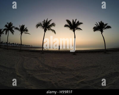 Man practicing yoga at the ocean beach in salalah Oman Stock Photo