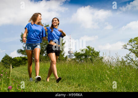 Two young women taking a walk in the countryside Stock Photo