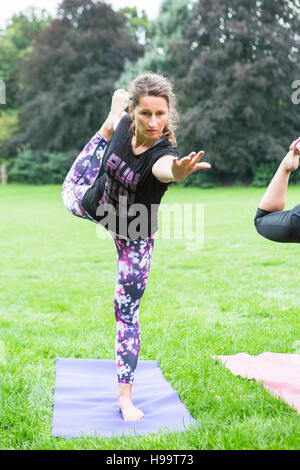 Two young women practicing balance acro yoga pose (637787)