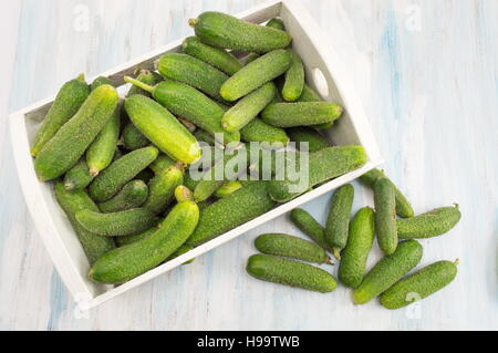 Fresh raw cucumbers in a wooden box Stock Photo