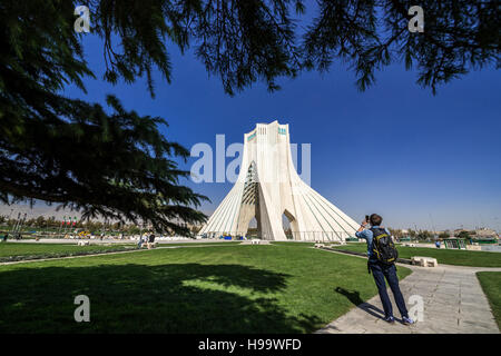 Tourist takes photo of Azadi Tower, formerly known as the Shahyad Tower, located at Azadi Square in Tehran city, Iran Stock Photo