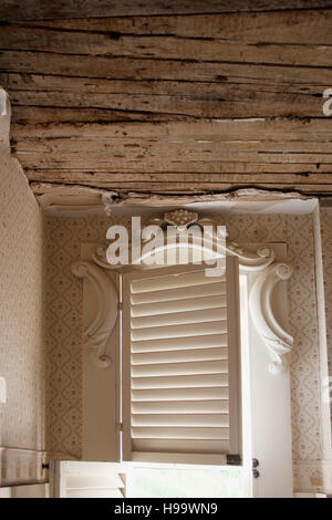 Antique window and ceiling in need of renovation and repair. Stock Photo