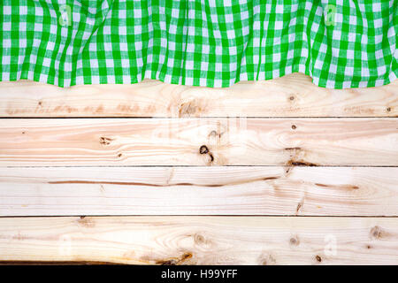 Green tablecloth on wooden table, top view Stock Photo