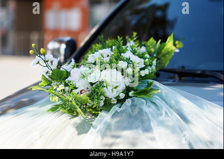 wedding car decorated with flowers on the hood Stock Photo