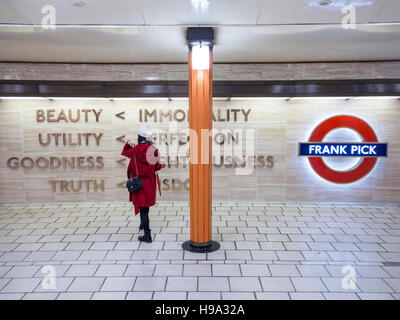 Passengers walk past the memorial to Frabk Pick at Piccadilly Circus Stock Photo