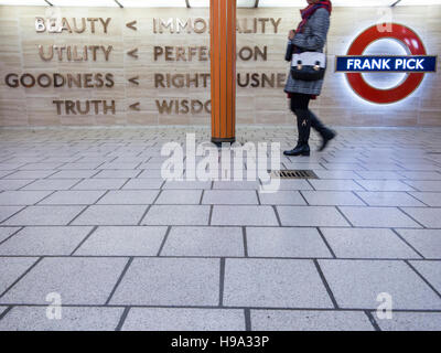 Passengers walk past the memorial to Frabk Pick at Piccadilly Circus Stock Photo