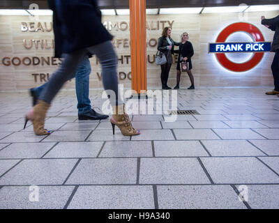 Passengers walk past the memorial to Frabk Pick at Piccadilly Circus Stock Photo