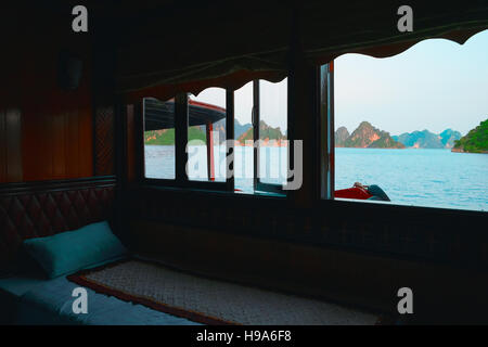 Indochina junk cruise to Halong Bay, Vietnam, Southeast Asia. Panoramic window in cabin. View from room window. Ha Long Bay. Stock Photo