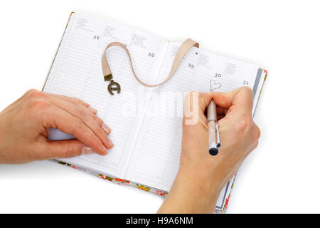 Notebook opened with female hands writing Stock Photo