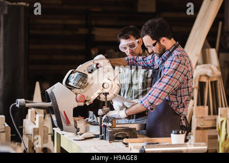 Inspector and carpenter discuss the process of making wood products for furniture Stock Photo