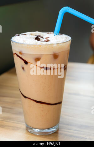 Iced coffee latte with chocolate sauce on wooden table Stock Photo