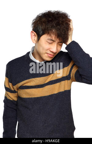 Closeup portrait, stressed young asian man, hands on head with bad headache, isolated background on white. Negative human emotion facial expression fe Stock Photo