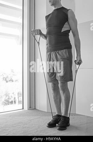 Performing exercises with resistance rope fitness Stock Photo