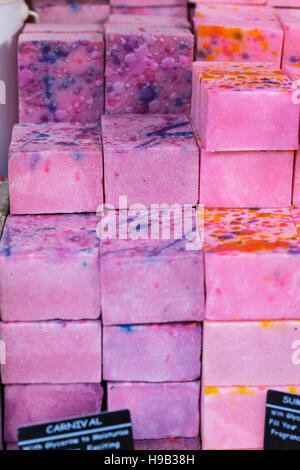 Colorful pink and purple marbled blocks of handmade soap on stall at craft market Stock Photo