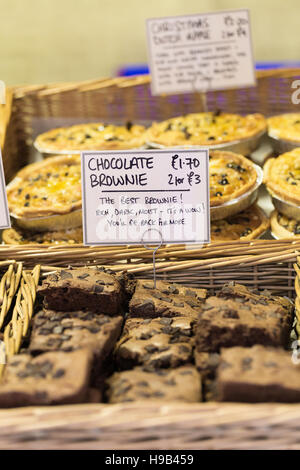 Brownies and pastry tarts food on sale  in baskets at farmers market Stock Photo