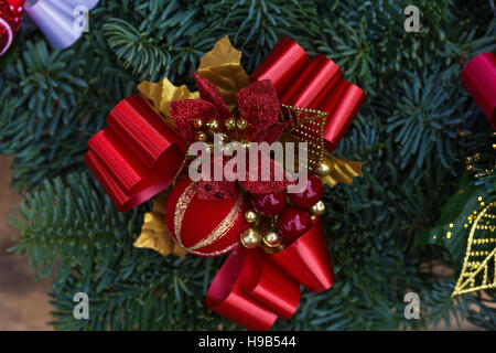 Red, gold, green spruce fir holly foliage forming Christmas wreath garland decoration decor Stock Photo