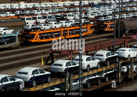 New cars on railway transport wagons, marshalling yard Munich-Allach, Munich, Germany Stock Photo