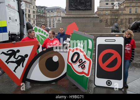 Trafalgar Square, UK. 21st Nov, 2016. Metropolitan Police Cycle Safety Team exchanging places event in Trafalgar Square London. People held large placards and road safety signs to enforce the importance of things such as no mobile phone use, drink driving etc while driving which are all illegal and very distracting to motorists Credit:  Keith Larby/Alamy Live News Stock Photo