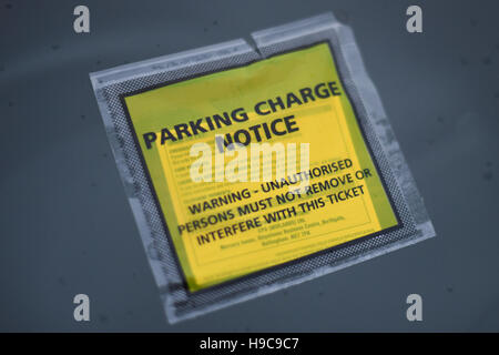 Penalty Charge Notice on windscreen of car. Parking ticket on rainy windscreen Stock Photo