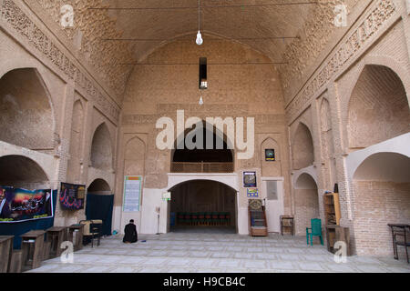 Iranian shiite man praying inside jameh mosque, Isfahan province, Ardestan, Iran Stock Photo