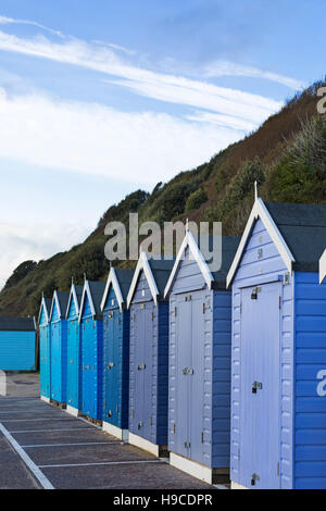 Shades of blue beach huts on promenade between Boscombe and Bournemouth, Dorset UK  in November Stock Photo