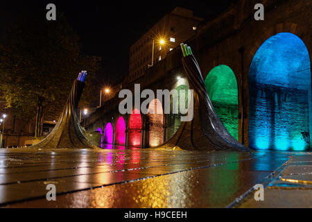 Illuminated arches near Bradford Forster Square, Railway Station, with the art installation called Fibres in the foreground. Stock Photo