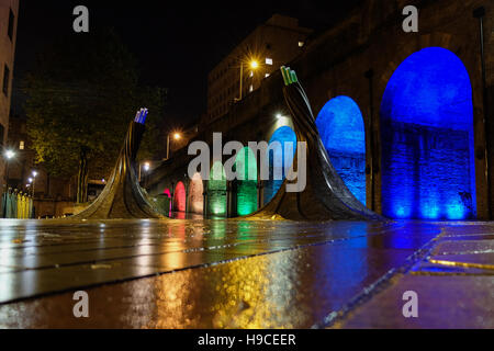 Illuminated arches near Bradford Forster Square, Railway Station, with the art installation called Fibres in the foreground. Stock Photo