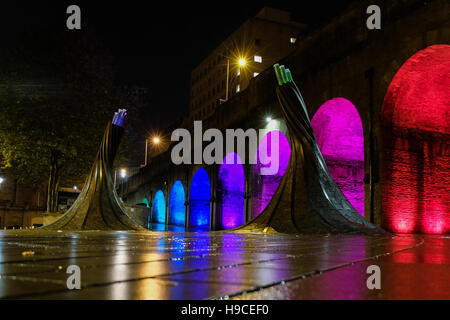 Illuminated arches near Bradford Forster Square, Railway Station, with the art installation called Fibres in the foreground. Stock Photo