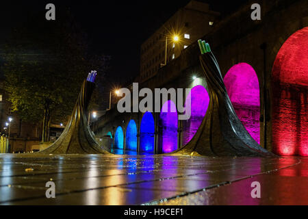 Illuminated arches near Bradford Forster Square, Railway Station, with the art installation called Fibres in the foreground. Stock Photo