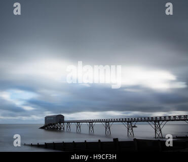 Long exposure of Selsey Lifeboat Station in West Sussex, UK, with dramatic sky. Moody abstract. Stock Photo