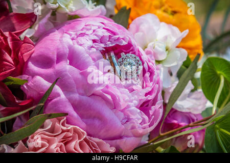 Wedding rings in bridal bouquet flowers Stock Photo