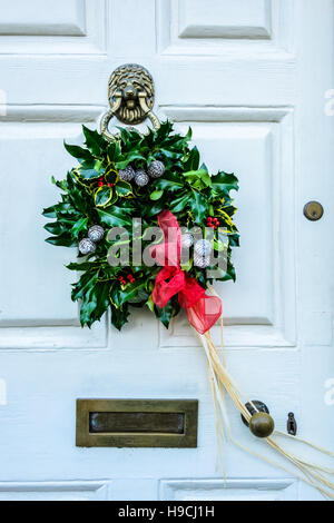 Christmas holly wreath on front door Stock Photo