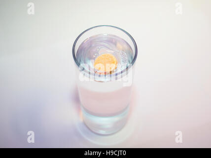 General view of an effervescent vitamin C tablet in a glass of water. Stock Photo