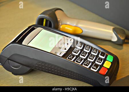 Bank terminal with hand reader of barcode Stock Photo