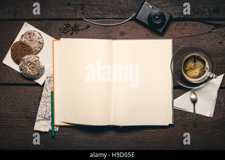 Blank page of notepad on the wooden table, honey-cake, compact camera, pencil and cup of espresso Stock Photo