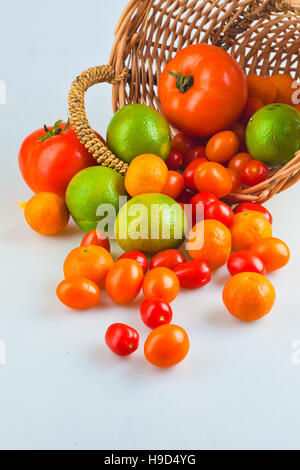 Assortment of exotic fruits in basket, isolated on white Stock Photo