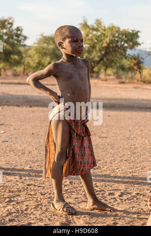 A young boy from indigenous Himba people tribe in traditional clothes at Kunene Region of Namibia Stock Photo