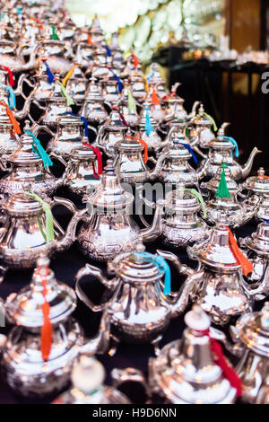 Traditional Moroccan silver tea pots for sale at a stall in a Marrakesh souk