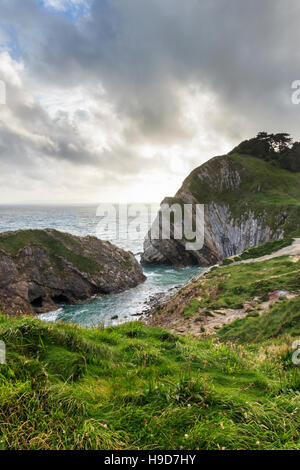 Storm clouds gathering over Lulworth Cove, Dorset, England, UK, on a summer evening Stock Photo