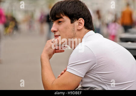 Portrait of a dark haired young Russian man, Gorky Park, Moscow, Russia Stock Photo