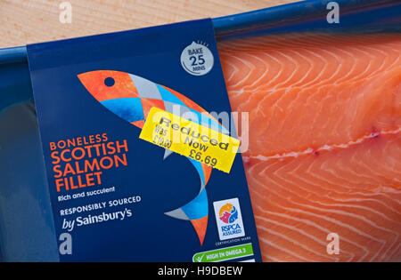 Close up of reduced label yellow sticker on pack of chilled fish salmon fillet fillets England UK United Kingdom GB Great Britain Stock Photo