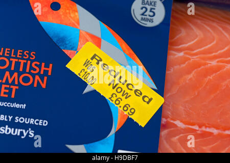 Close up of reduced label yellow sticker on pack of chilled fish salmon fillet fillets England UK United Kingdom GB Great Britain Stock Photo