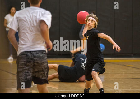 High school athletes in San Clemente, CA, play a dodge ball game in the school gymnasium. Stock Photo